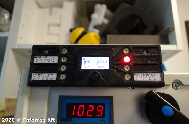 Image showing a custom
device with buttons, lights and digital display, on top of another
instrument.